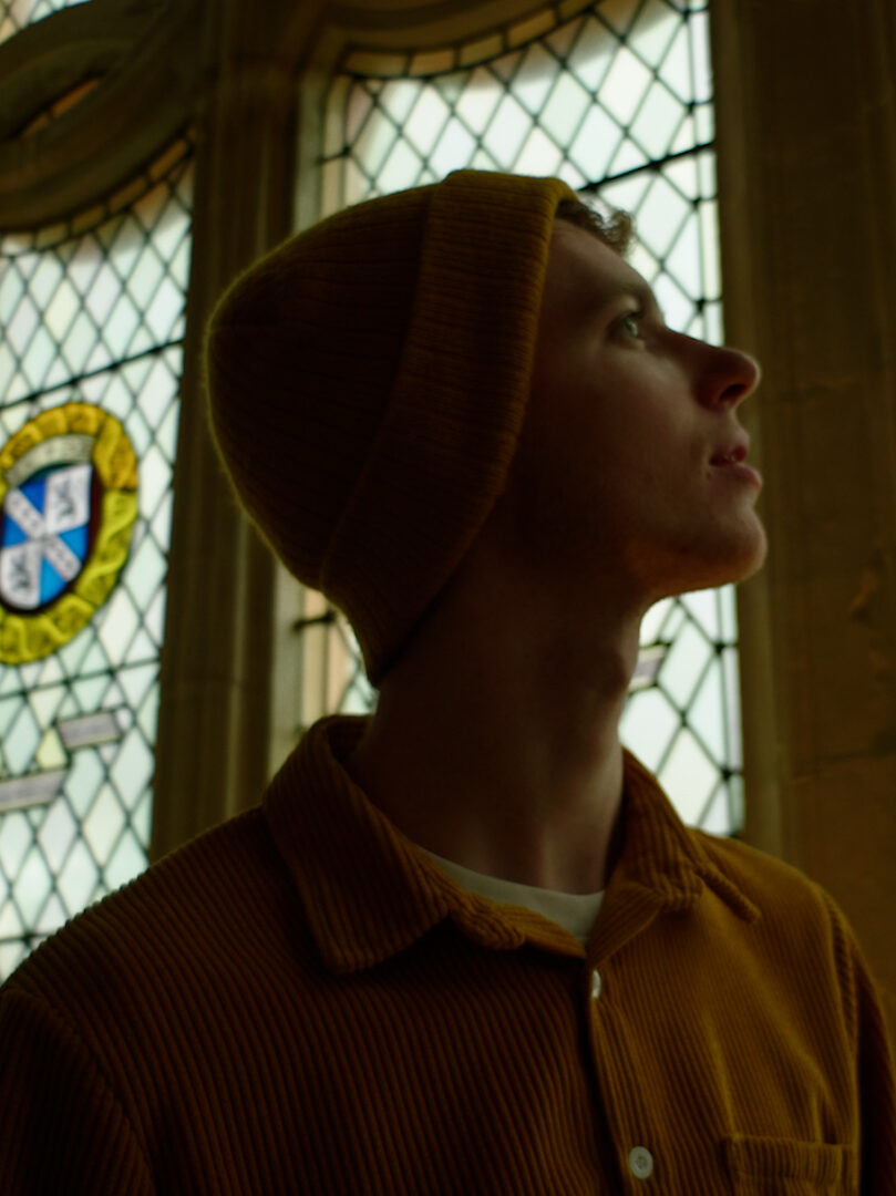 Screengrab from sustainable production for Historic Environment Scotland. Actor looks out of stain glass windows at Stirling Castle. 
